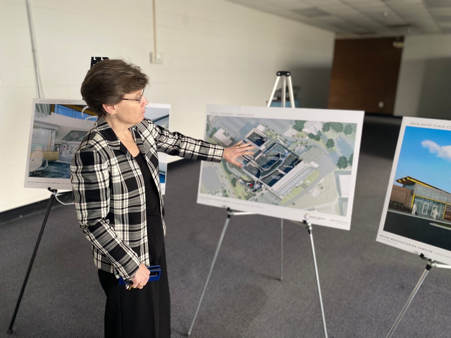 Near the entrance to the former Magneti Marelli facility, CCCC's Margaret Roberton points out a plan to transform the space into a state-of-the-art training and technology center.